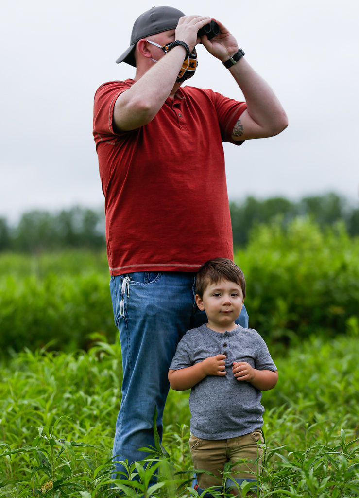 Jake Clifford and his son Calvin Clifford, 3, watch as the eagle, Dorothy Parker, flies away